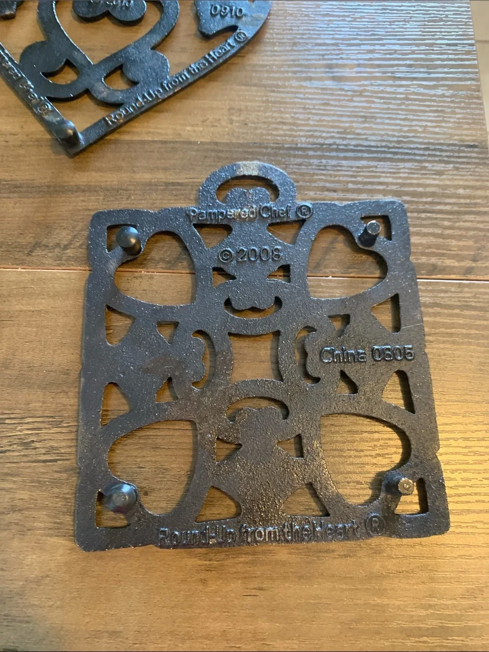 The Pampered Chef Copper-Tone Ornate Trivet Set.